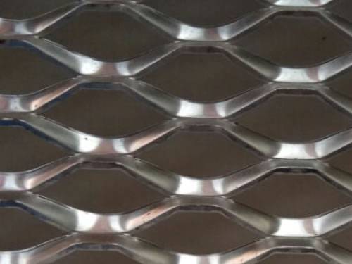 Stainless steel expanded metal details with raised surface and hexagonal holes.