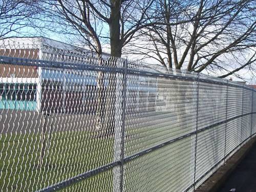 Expanded metal fencing with gray surface and square holes in the military.